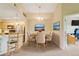 Dining room with seating for four, chandelier, and views of the kitchen and office at 8726 S Kline St # A204, Littleton, CO 80127