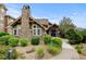 Beautiful stone accented building, featuring well-manicured landscaping, leading to a charming entrance with double doors at 8726 S Kline St # A204, Littleton, CO 80127