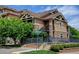 Attractive condo building featuring stone accents, brown siding, and well-maintained landscaping with a blue sky backdrop at 8726 S Kline St # A204, Littleton, CO 80127