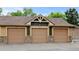 Close up of three garages with decorative accents and the building number 8741, offering convenient parking in a well-kept community at 8726 S Kline St # A204, Littleton, CO 80127
