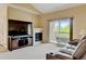 Bright living room with fireplace, TV, and sliding glass door to the balcony, creating a comfortable and welcoming space at 8726 S Kline St # A204, Littleton, CO 80127