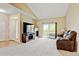 Inviting living room featuring a fireplace, media console, and sliding glass doors to the balcony for natural light at 8726 S Kline St # A204, Littleton, CO 80127