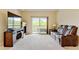 Relaxing living area with a fireplace, large TV, plush sofa, and sliding glass doors to the balcony, offering a serene view at 8726 S Kline St # A204, Littleton, CO 80127