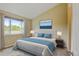 Main bedroom featuring a king bed, decorative rug, and a large window with natural lighting at 8726 S Kline St # A204, Littleton, CO 80127