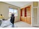 Functional home office with a large built-in bookshelf, desk, and window, providing ample storage and natural light at 8726 S Kline St # A204, Littleton, CO 80127