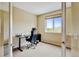 Bright home office with desk, chair, and large window overlooking the outdoors, creating a perfect work environment at 8726 S Kline St # A204, Littleton, CO 80127