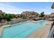 Overhead view of a community pool with plenty of lounge chairs and umbrellas, perfect for enjoying sunny days and outdoor recreation at 8726 S Kline St # A204, Littleton, CO 80127