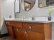 Mid-century modern bathroom vanity with wood cabinets and quartz countertop at 1750 Vance St, Lakewood, CO 80214