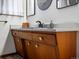 Mid-century modern bathroom vanity with wood cabinets and quartz countertop at 1750 Vance St, Lakewood, CO 80214