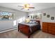 Spacious bedroom with wood bed frame, ceiling fan, and dresser at 1750 Vance St, Lakewood, CO 80214