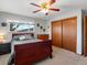 Bright bedroom with wood bed frame, ceiling fan, and sliding door closet at 1750 Vance St, Lakewood, CO 80214