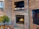 Brick fireplace with a warm, inviting fire at 1750 Vance St, Lakewood, CO 80214