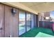 The spacious balcony has wood paneled walls, a large sliding glass door, and outdoor lighting at 3675 S Cherokee St # 110, Englewood, CO 80110