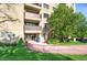Condominium building with landscaping, walkway, and a view of balconies on a sunny day at 3675 S Cherokee St # 110, Englewood, CO 80110