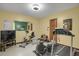 Exercise room with yellow walls, a treadmill and weight machines at 3675 S Cherokee St # 110, Englewood, CO 80110