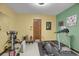 Exercise room with yellow walls, a treadmill and weight machines at 3675 S Cherokee St # 110, Englewood, CO 80110