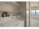Laundry room with washer, dryer, shelves, and view of living room at 3675 S Cherokee St # 110, Englewood, CO 80110