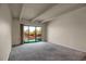 Living room has sliding glass doors to balcony, neutral paint, and lots of natural light at 3675 S Cherokee St # 110, Englewood, CO 80110