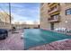 Community pool area with brick patio, grill, and seating; ideal for summer relaxation at 3675 S Cherokee St # 110, Englewood, CO 80110