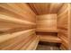 Relaxing sauna featuring natural wood walls, benches, and flooring, creating a warm and inviting atmosphere at 3675 S Cherokee St # 110, Englewood, CO 80110