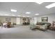 Open community sitting area with two tables, two sitting areas and carpeted floors at 3675 S Cherokee St # 110, Englewood, CO 80110