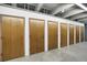 Hallway with a row of brown wooden storage units and concrete floors at 3675 S Cherokee St # 110, Englewood, CO 80110