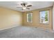 Spacious bedroom with neutral carpet, ceiling fan, and bright natural light from two windows at 2554 S Laredo Ct, Aurora, CO 80013