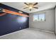 Bedroom painted in team colors, has ceiling fan and plush carpet at 2554 S Laredo Ct, Aurora, CO 80013