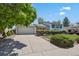 Home exterior features a driveway leading to a two-car garage and a well-kept front lawn at 2554 S Laredo Ct, Aurora, CO 80013