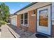 Home showcasing a well-lit front entrance, brick facade, and manicured landscape at 2554 S Laredo Ct, Aurora, CO 80013