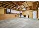 Spacious garage featuring a work bench area with upper and lower cabinets, and concrete flooring at 2554 S Laredo Ct, Aurora, CO 80013