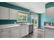 The kitchen features stainless steel appliances, white cabinets, and a window to the backyard at 2554 S Laredo Ct, Aurora, CO 80013