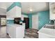 Kitchen featuring white cabinets, black appliances, and bright turquoise walls at 2554 S Laredo Ct, Aurora, CO 80013