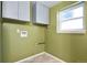 This laundry room features overhead cabinets, utility connections, and a window for natural light at 2554 S Laredo Ct, Aurora, CO 80013