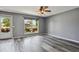 Living room features wood-look floors, large window, and ample space for entertaining at 2554 S Laredo Ct, Aurora, CO 80013
