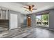 Spacious living room features wood-look floors, stairs, and a large window at 2554 S Laredo Ct, Aurora, CO 80013