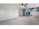 Open-concept living room with stairs and plush carpet, featuring a pop of teal at 2554 S Laredo Ct, Aurora, CO 80013