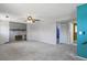 Open-concept living room with a brick fireplace and plush carpet at 2554 S Laredo Ct, Aurora, CO 80013