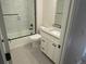 Bathroom featuring gray, hexagonal tile floor, sleek glass shower door, and a modern vanity at 1970 S Logan St, Denver, CO 80210