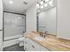 Modern bathroom features a glass-enclosed shower, granite countertop, and tile flooring at 1970 S Logan St, Denver, CO 80210