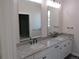 Bright bathroom featuring double sinks, granite countertops, and modern fixtures at 1970 S Logan St, Denver, CO 80210