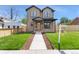 Charming two-story home featuring a manicured lawn, complemented by a welcoming walkway and a 'New Home' sign at 1970 S Logan St, Denver, CO 80210
