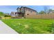 Expansive green lawn surrounding a newly built home, partially enclosed by a wooden fence enhancing its curb appeal at 1970 S Logan St, Denver, CO 80210