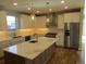 Spacious kitchen with large island, granite countertops, stainless steel appliances, and custom cabinetry at 1970 S Logan St, Denver, CO 80210