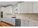 Modern kitchen with custom white cabinets, stainless appliances, and marble countertops at 1970 S Logan St, Denver, CO 80210