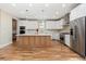 Modern kitchen featuring a large island, stainless steel appliances, and a built-in oven at 1970 S Logan St, Denver, CO 80210