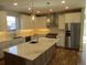Spacious kitchen boasts a large island, stainless steel appliances, and custom cabinetry for ample storage at 1970 S Logan St, Denver, CO 80210