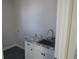 Laundry room featuring granite countertop and stainless sink with white cabinets, offering practical functionality at 1970 S Logan St, Denver, CO 80210