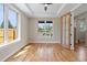 Sunlit living room features hardwood floors, large windows, and a modern ceiling fan enhancing the bright, airy space at 1970 S Logan St, Denver, CO 80210