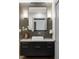 Elegant bathroom with dark vanity, white sink, and modern fixtures at 105 Fillmore St # 204, Denver, CO 80206